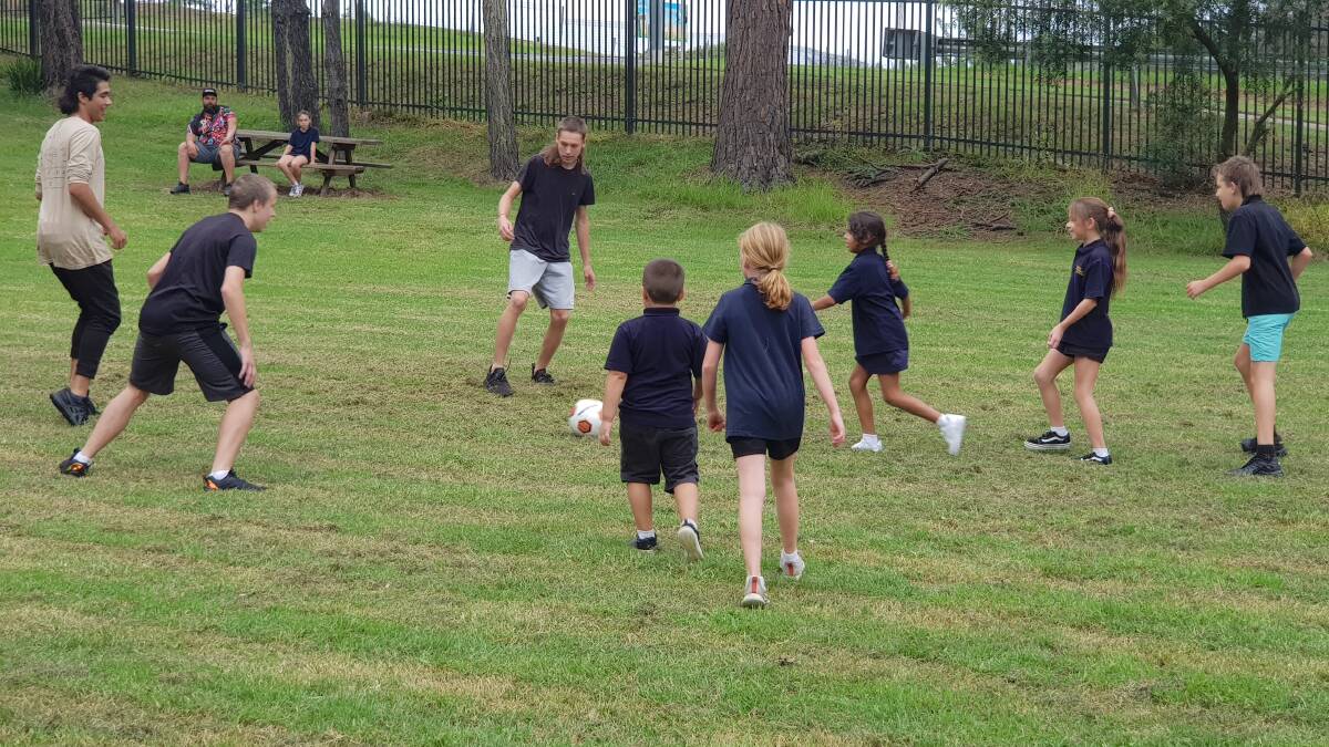 Mogo Primary school students enjoy a friendly game of soccer with the PCYC Fit 4 Work crew, where some were former students of the school who enjoyed catching up with teachers.