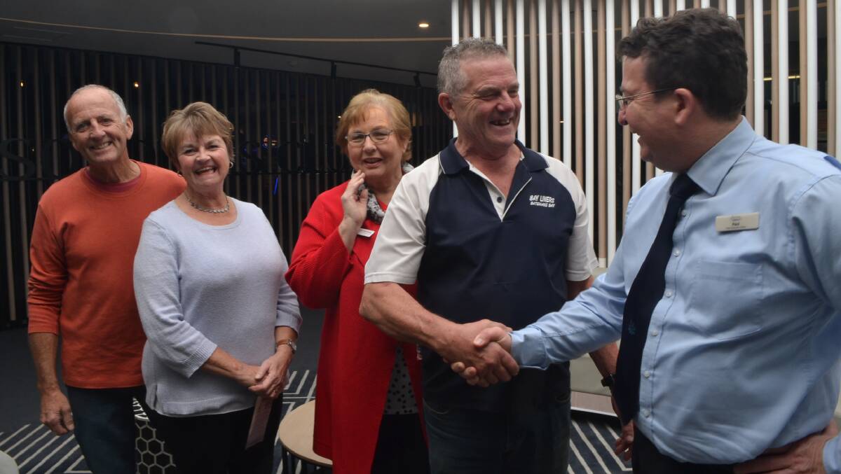 Muddy Puddles representatives and the Batemans Bay Hospital Auxiliary get together to thank the Batemans Bay line dancers for their donation. Alan Rosier of the line dancing group shakes the hand of Soldiers Club CEO Paul Briddlestone. (far right)