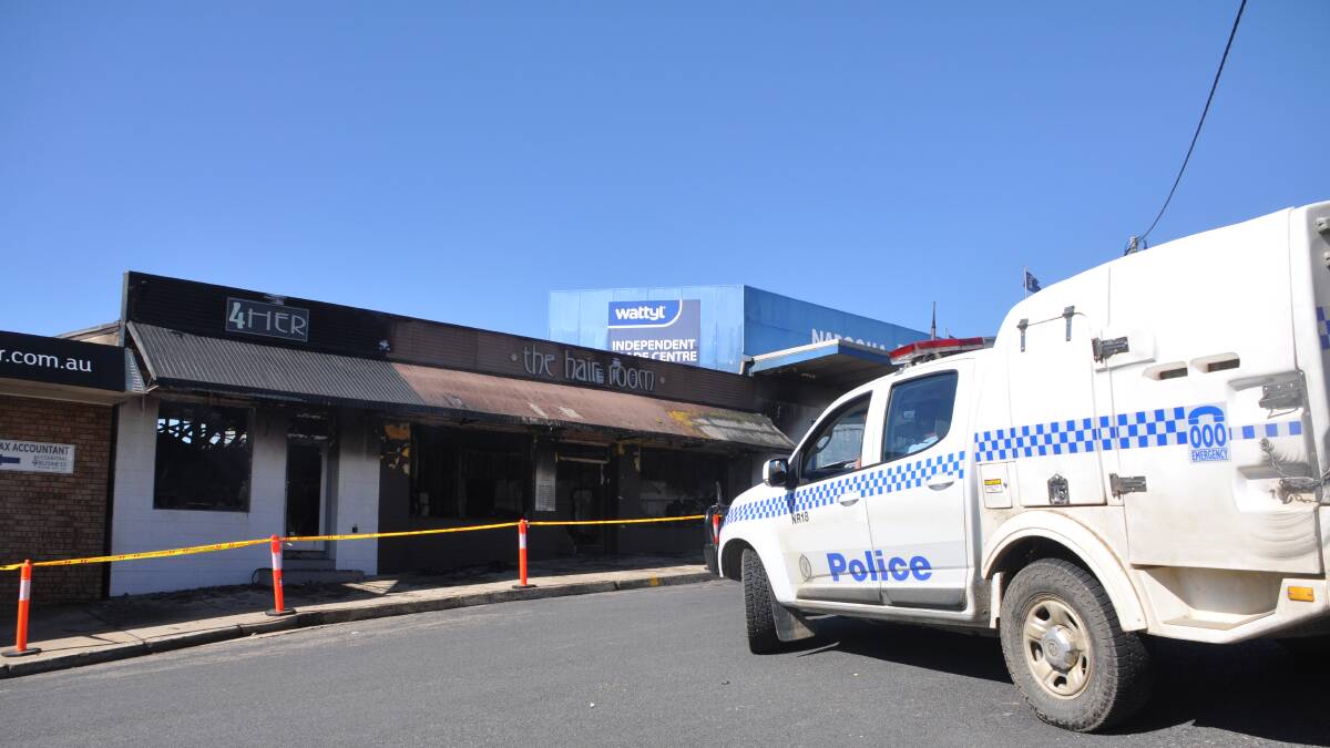 Police establish a crime scene at Noorooma Crescent after two businesses were destroyed by fire on Sunday evening, September 21. 