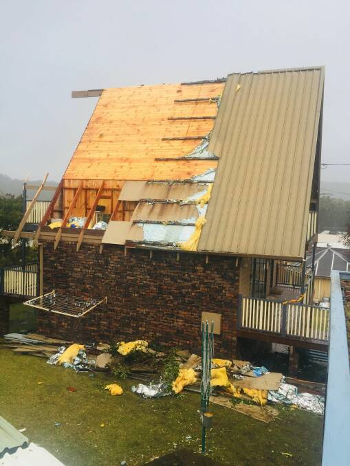 Crews were confronted with a very large debris field consisting of clip lock roofing and bonded asbestos sheeting after strong wind tore the roof off a home in Kioloa, a Fire and Rescue spokesman says. Picture: Batemans Bay FRNSW.
