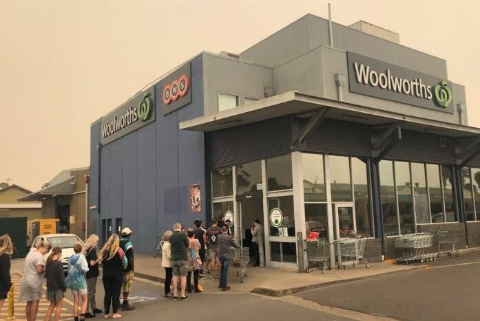 TIMES OF CRISIS: A line extends out the doors of the Moruya Woolworths during the bushfire crisis earlier this year. Police say supermarkets are a high-risk area for social distancing rules to be broken. 