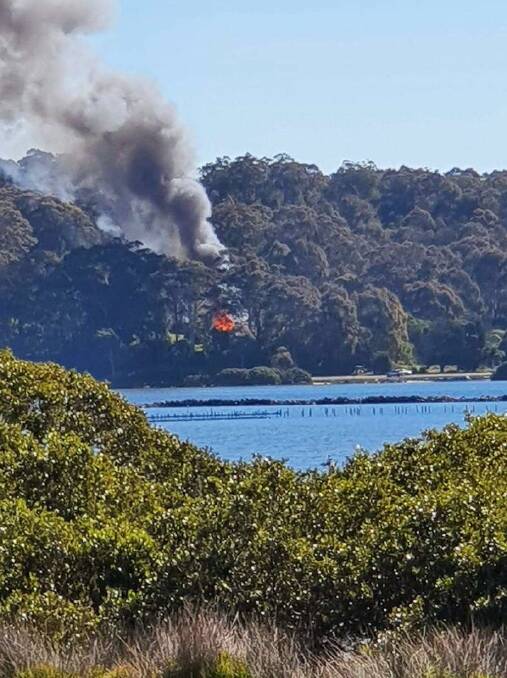 The house fire pictured from across the Moruya River on Sunday, August 15. Picture: Supplied. 