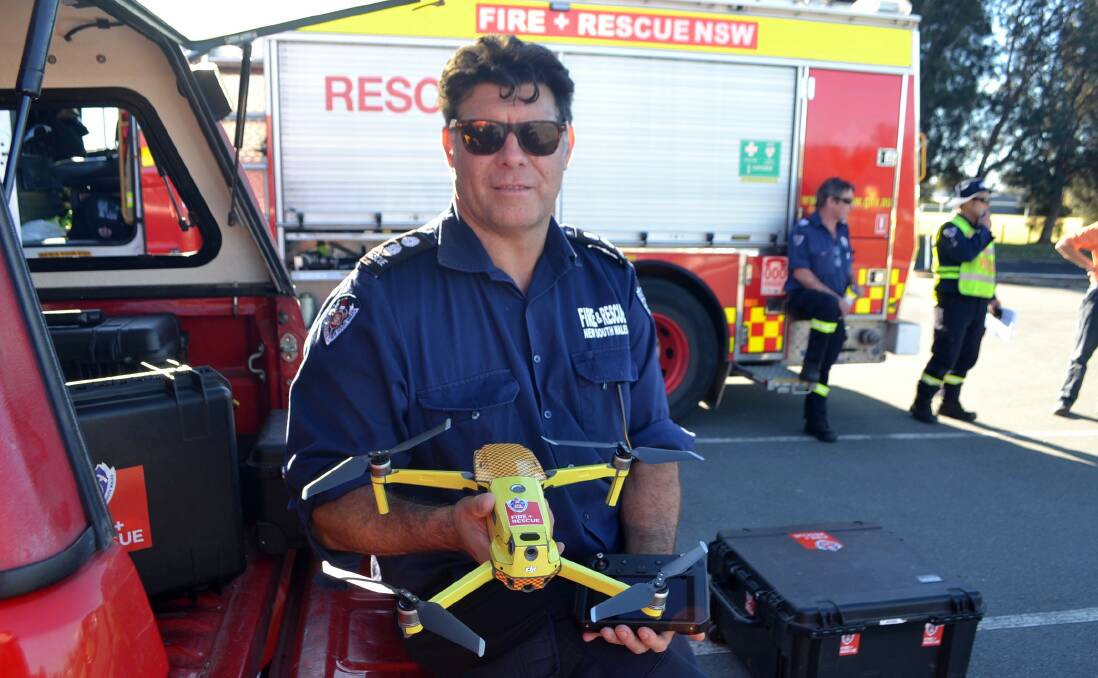 Batemans Bay Fire and Rescue station commander Craig Mashman holding a Matrice 2 Dual Enterprise.
