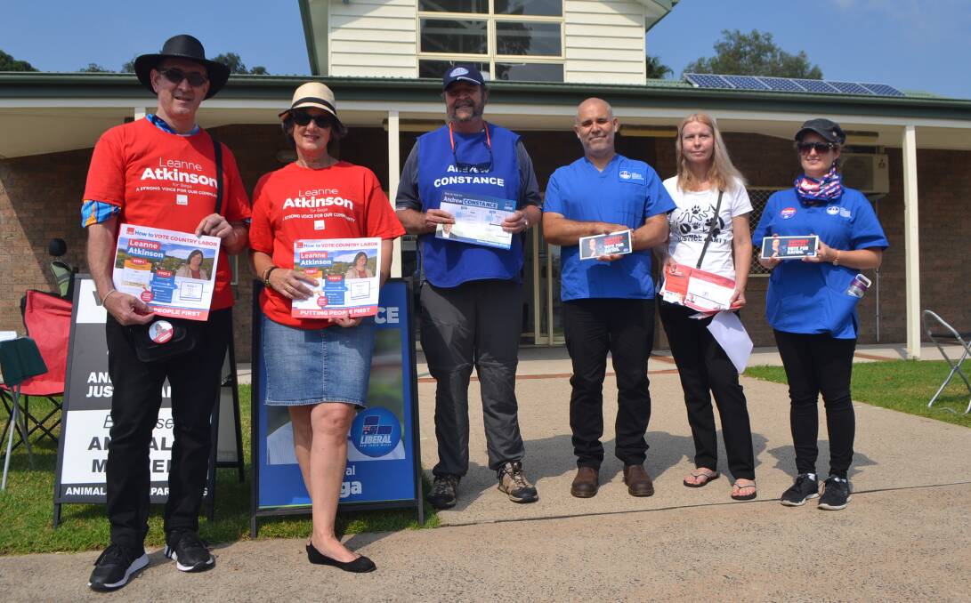 Campaign representatives handing out election collateral at the Batemans Bay Community Centre on Monday, March 11. 