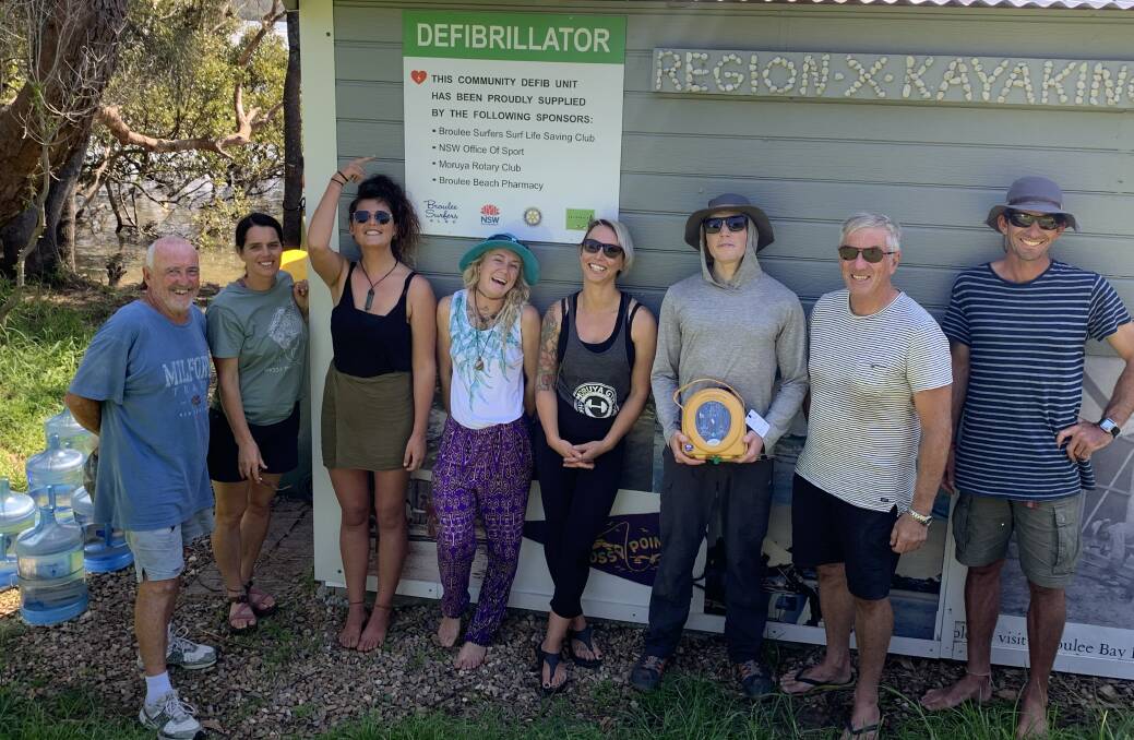 Heart starter: Staff of the Mossy Point Boat Ramp Kiosk learn how to use the defibrillator with Broulee Surf Club trainers Peter Halpin and Al Veness. 