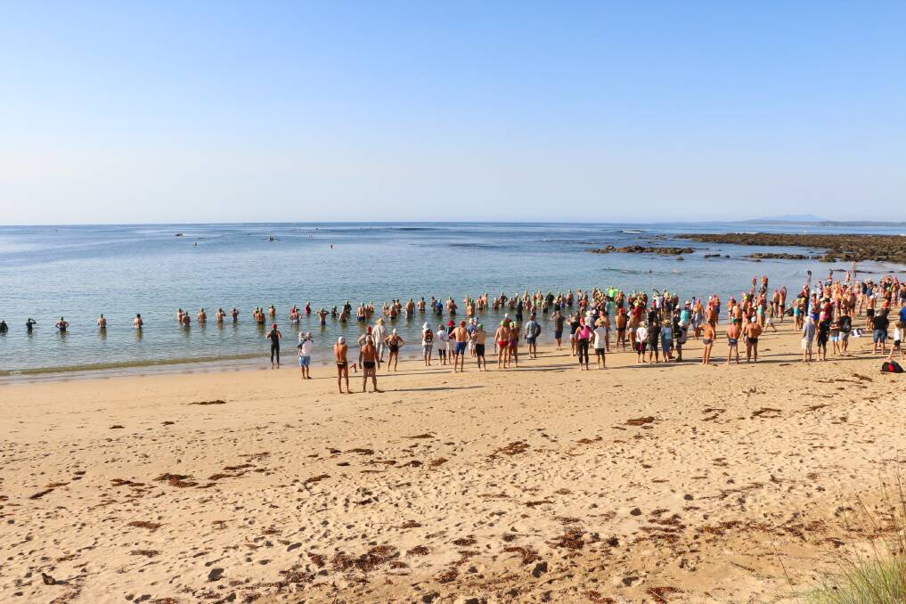 Competitors gather at the start line in perfect swimming conditions at the 2018 event. 