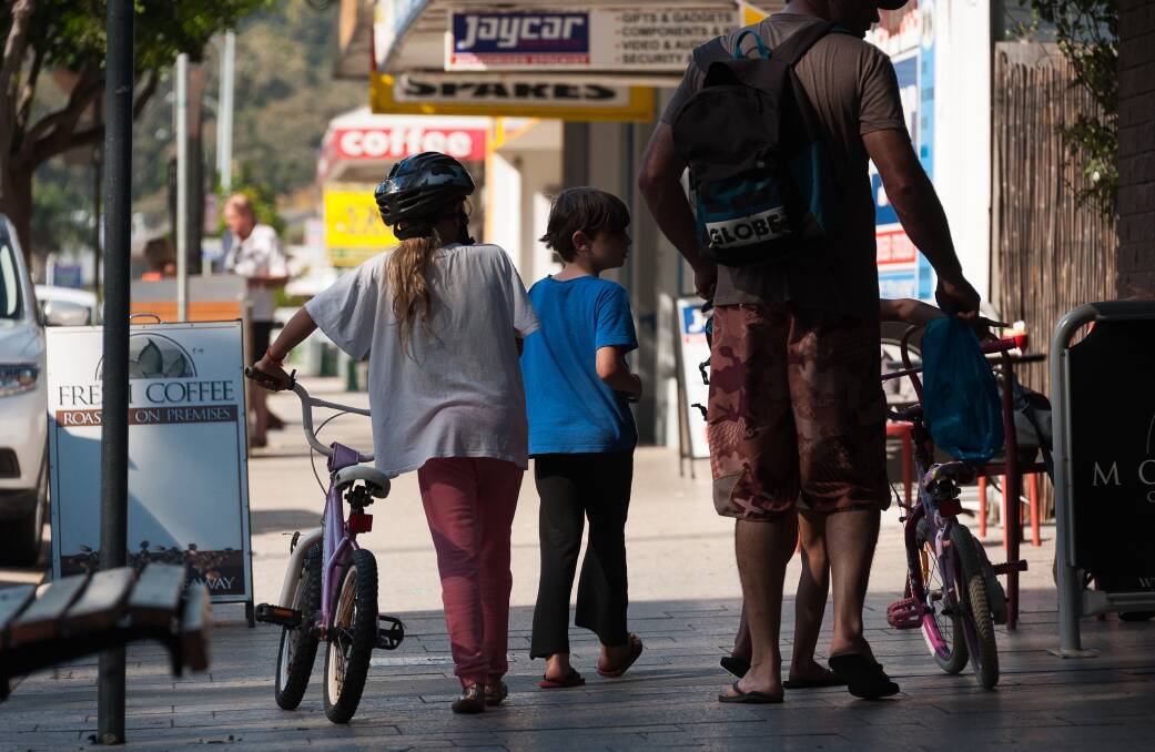 A family walks the main street of Narooma. Image: Eurobodalla Council.