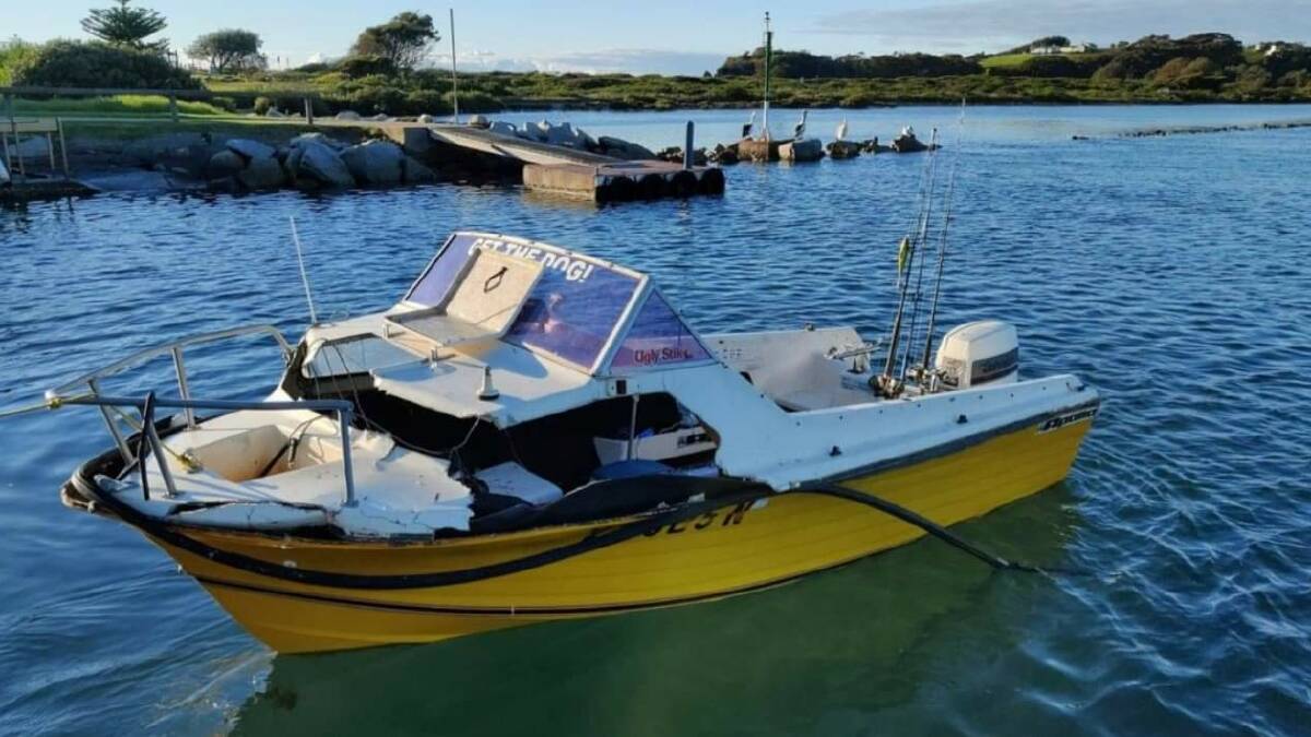 The damaged 4.9 metre cabin runabout. Witnesses say the two men were lucky to make it back to shore. Image: Supplied. 