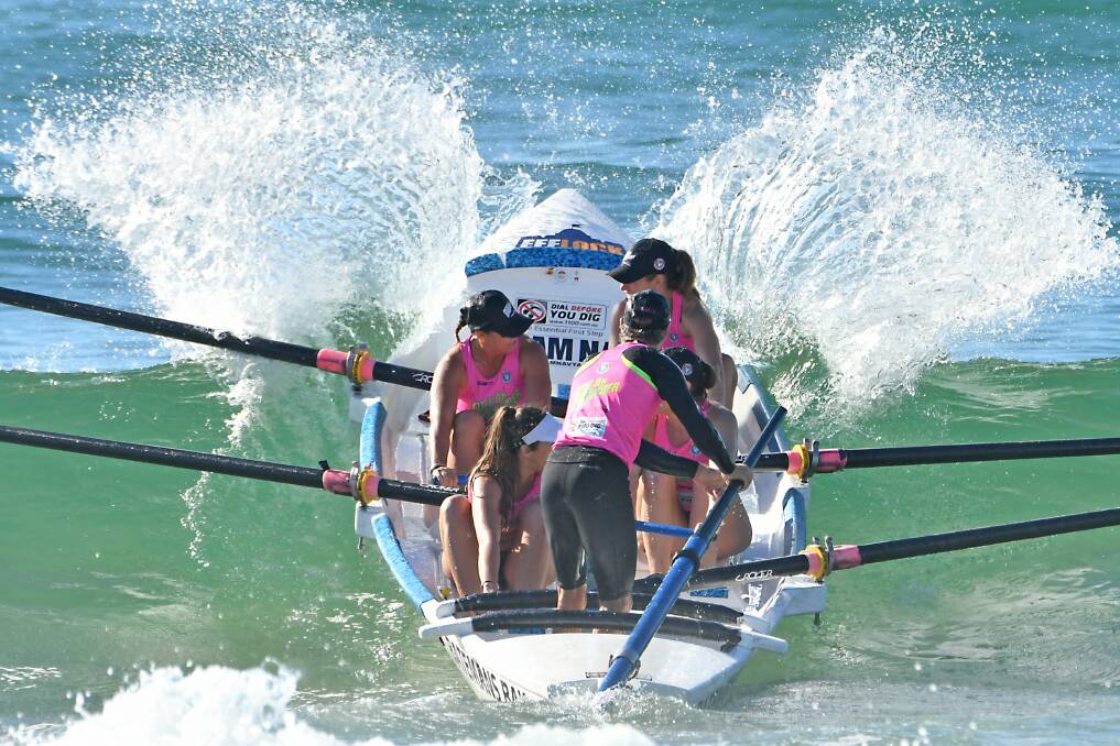 Power: The One Life Batemans Bay womens crew push through a wave in the Ocean Thunder Surfboat Series on Saturday. Image: Harvpix. 