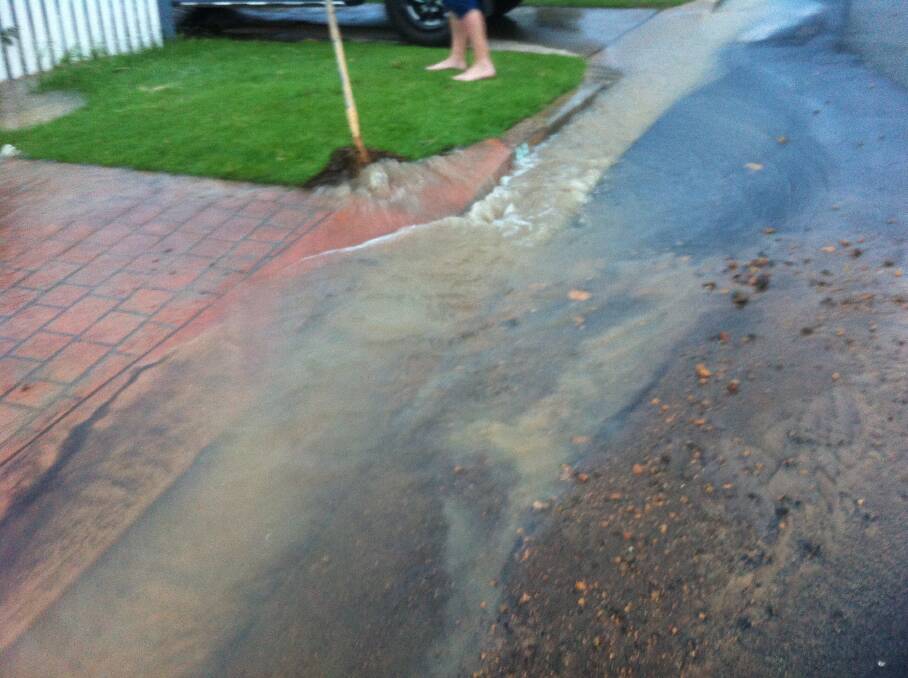 WET NIGHT: Resident Guy Miller's photograph shows dirt expelled and water flowing down the street. 
