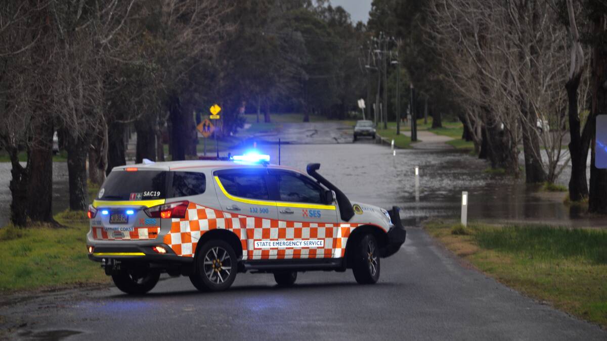 SES inspects flooding on Shore Street, Moruya, outside the Moruya Bowling Club on Sunday afternoon, August 9. 