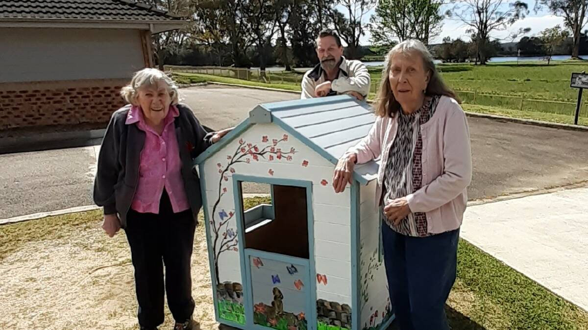 TEAM EFFORT: Moruya IRT residents Elaine Johns, Rowan Field and Melva Hagen with the cubby house. Image: Supplied.