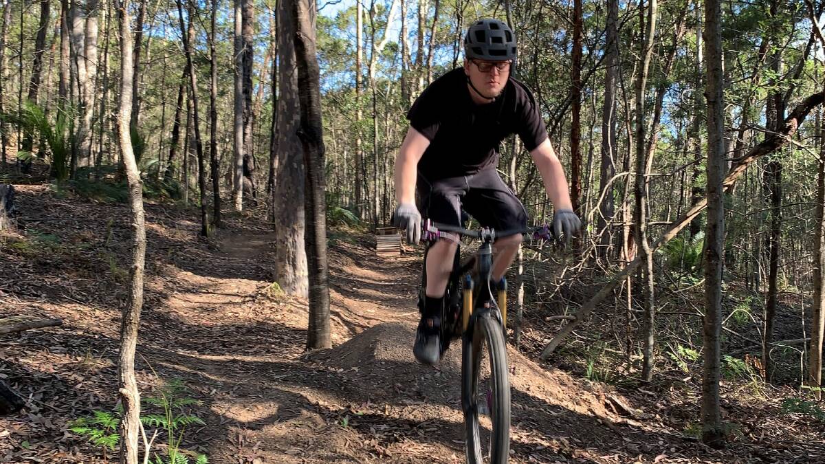 A mountain biker takes on a section of jumps riding stage one of Narooma's trails network. Image: Supplied. 