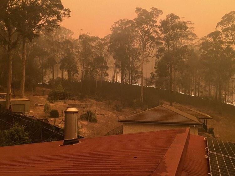 A rooftop view of a Grandfathers Gully property at Lilli Pilli during the New Year's Eve bushfires. Picture: Georgie Rowley. 