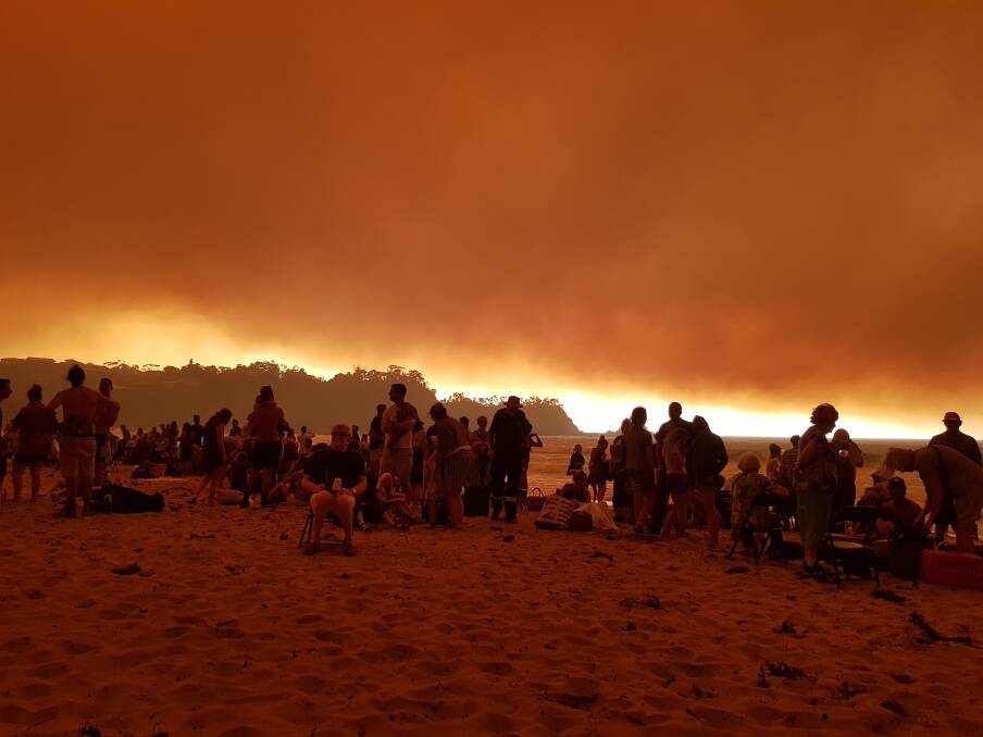 SCARY DAY: Meagan Callaghan captures the moment mid-morning on Malua Bay Beach on New Year's Eve when fire sent people fleeing.