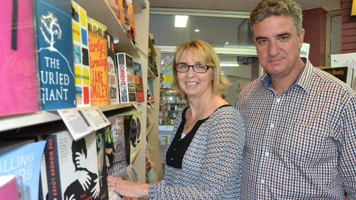 GOOD READ: Michelle and Garry Evans sort through the new release books on the shelves at Harbour Bookshop in Ulladulla in 2015, the 15th year their store was in business.