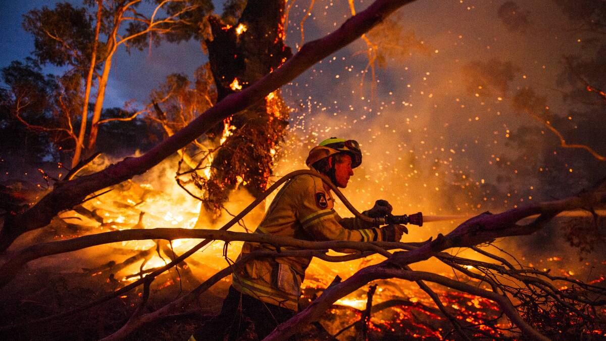 HEROIC: Throughout the emergency thousands of volunteer firefighters put their lives on the line up and down the coast. Photo: Dion Georgopolous 