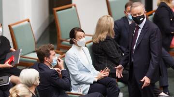 Prime Minister Anthony Albanese speaks to independents shortly before the government's climate bill was passed in the House of Representatives. Picture: Sitthixay Ditthavong