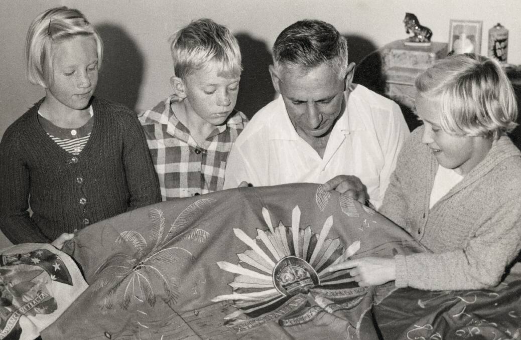 Pat Sullivan showing his embroidery to his family. Picture: Australian War Memorial