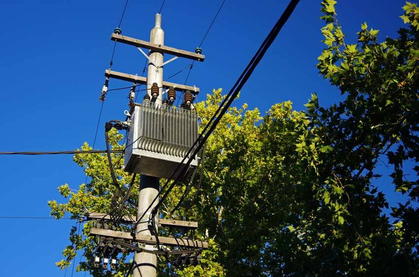 A power transformer on a concrete pole and power lines in Canberra. Credit: Simon McGill / Moment / Getty Images.
