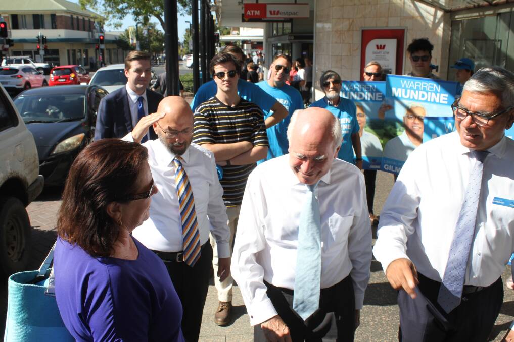 TAKING IT IN HIS STRIDE: Warren Mundine (right) and John Howard in Nowra on Wednesday. Picture: Rebecca Fist