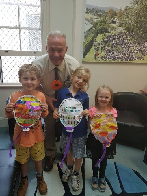 Moruya Public School principle  Peter Johnson with students during celebrations of Harmony Day and Purple Day for Epilepsy on Tuesday, March 21.