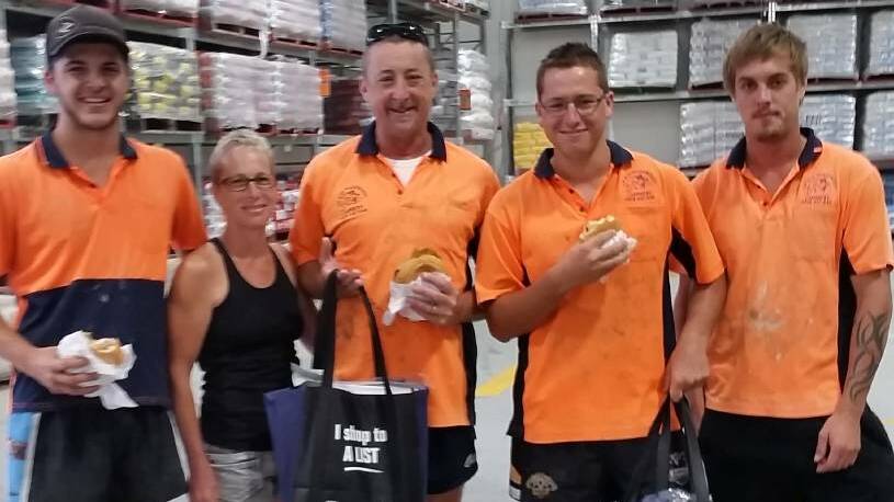 BBQ BREKKIE: The crew from AM & SA Meadowcroft Carpentry, Narooma, chow down on bacon & egg rolls at a previous breakfast at Bunnings, Batemans Bay.