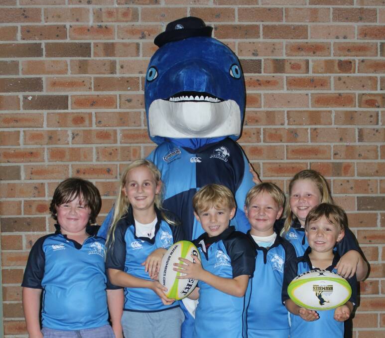 The Broulee Dolphins mascot with Oscar Grant, Elle Holmes, Asher Brady, Liam Cairney, Mikayla Cairney and Noah Grant.