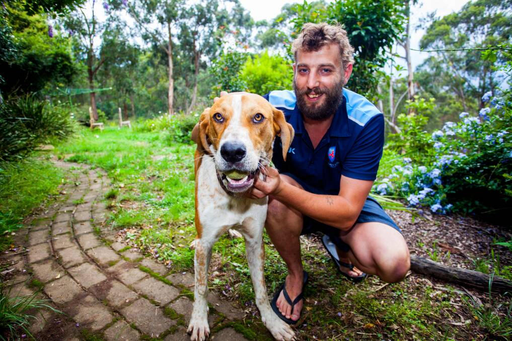 Back together: Lou the dog and his owner Shaun Matthyssen enjoy a relaxing time in their garden after a week long ordeal. Picture: Rachel Mounsey