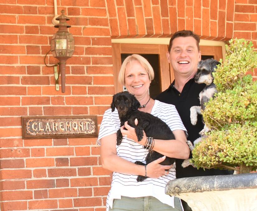 Andrea and Darren Rutley, pictured here with 'Snoop Dog' and 'Charlie Bear' on the front verandah of Claremont. The couple is working remotely from Tenterfield during their stayovers.