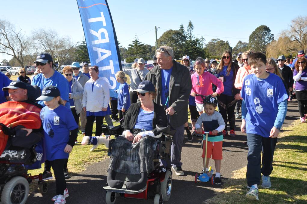 D'FEET MND: Walkers take part in the 2017 Walk to D'Feet Motor Neurone Disease at Corrigans Beach Reserve. Pictured centre, MND sufferer Sharon Penman with her husband, Phil.