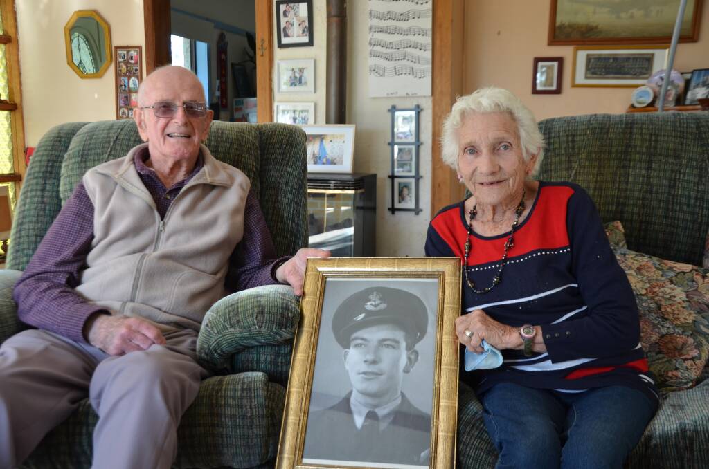UNITED: World War II Bomber Command veteran Bob Wade with Joan Smith holding a photo of her late husband and RAF Bomber Command veteran Jim Smith.