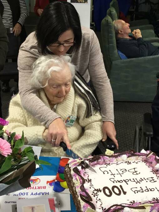 Catalina's Betty Rodel cuts her 100th birthday cake.