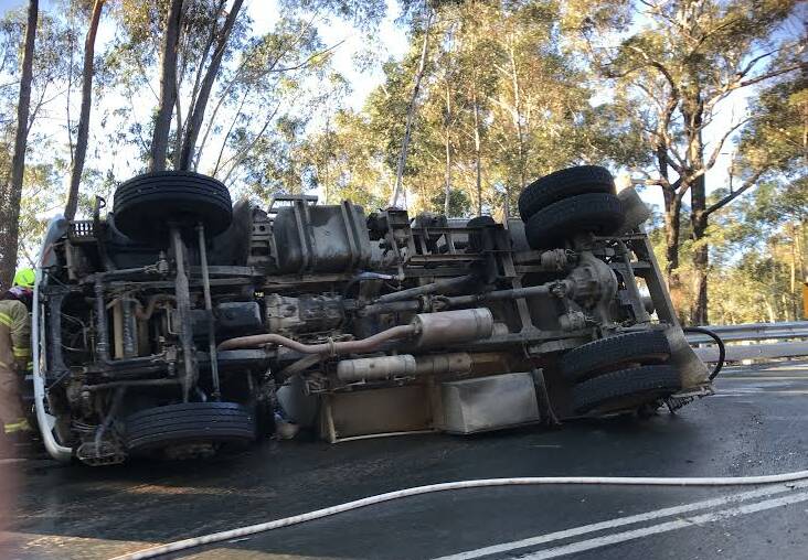 TRUCK CRASH: A sewage truck has rolled on the Clyde Mountain on Saturday morning. Photo: Amy and James Collins.