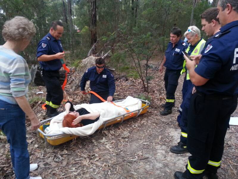 HELPING HAND: Emergency crews come to the aid of bushwalker Heather Belevi after she broke her ankle in a fall in Sunshine Bay earlier this month. Photo: Josef Belevi.