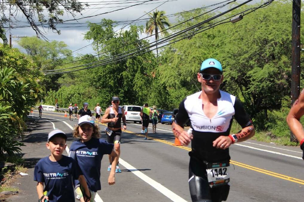 FINISH LINE: The Eurobodalla's own Ironman Daniel Beby approaches the finish line with his two sons in tow during this year's World Ironman Championship in Hawaii.