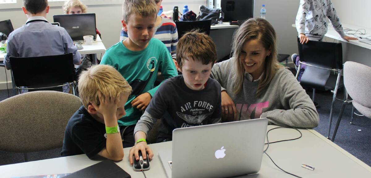 MORE THAN A GAME: Broulee Public School students share a love of all things games with Stephanie 'Hex' Bendixsen at the Gamer Dev Jam.