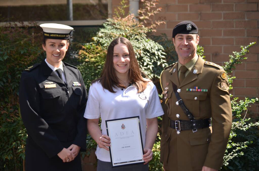 AWARDED: Lily Attwood (centre) with Leading Seaman Janelle Price and Captain Aaron Kogler.