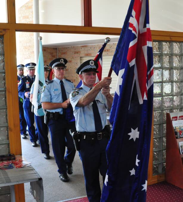 HONOUR: Senior Constable Mick Roberts leads the flag party into as recent South Coast Police District Remembrance Day service.