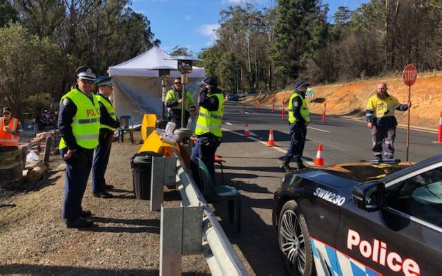IMPORTANT ROLE: Officers from across the South Coast Police District have joined navy and army personnel from the Australian Defence Force along with staff for Transport for NSW in manning a checkpoint at Timbillica. Photo: Supplied