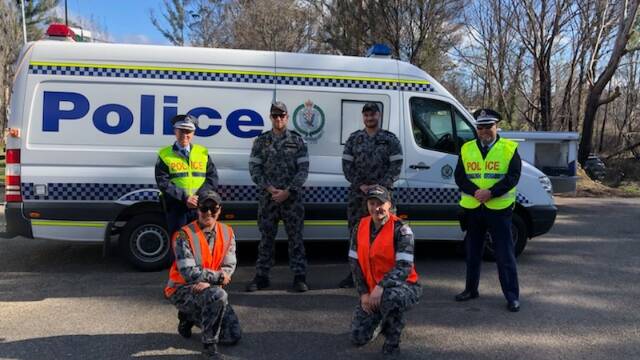 TEAM: Officers from across the South Coast Police District have joined navy and army personnel from the Australian Defence Force along with staff for Transport for NSW in manning a checkpoint at Timbillica. Photo: Supplied