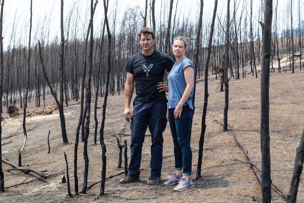 Wiped out: Gary Henderson and Sara Tilling inspect the devastated remnants of bushland that surrounded their Cobargo wildlife sanctuary. Photo: supplied. 