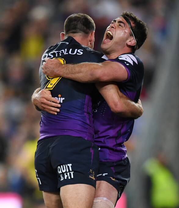 Cheering: Bega's Dale Finucane celebrates with captain Cameron Smith after winning last year's NRL grand final. Picture: AAP
