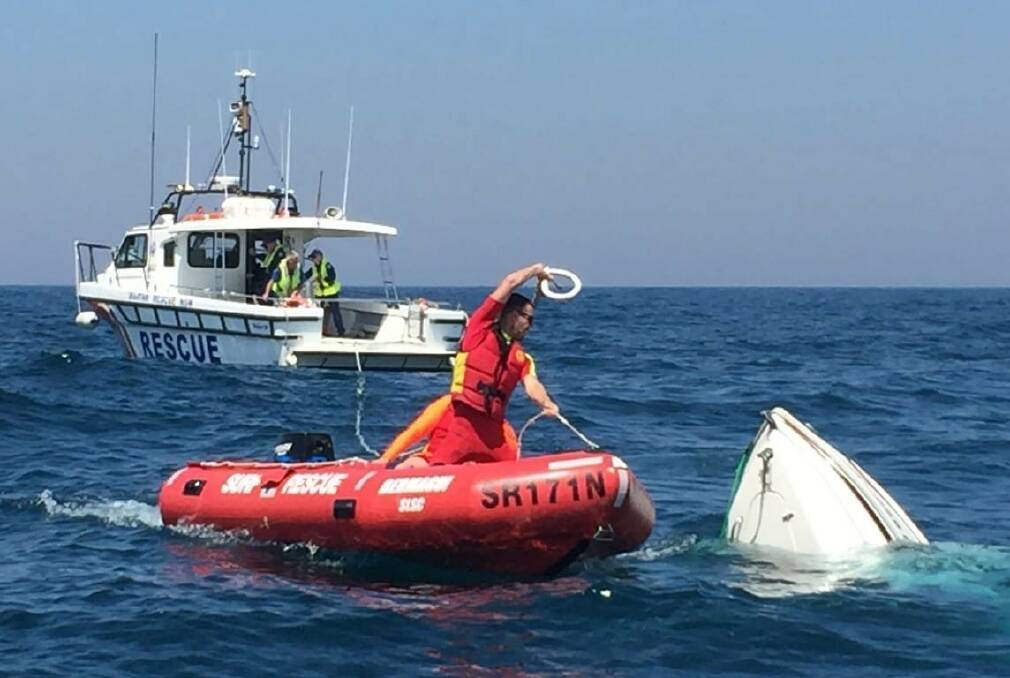 Urging safety: Lifesavers work to recover a boat during a rescue near Bermagui in May. Picture: Surf Life Saving NSW. 