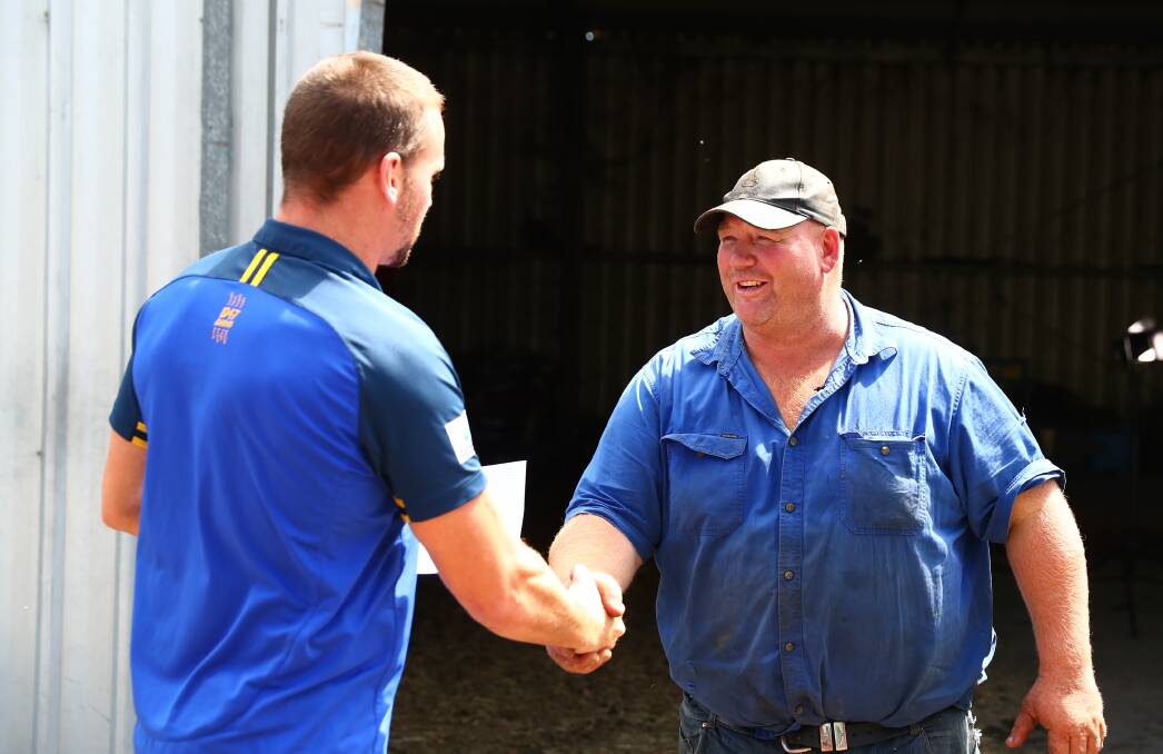 All smiles: Cobargo farmer and former Parramatta Eels player Tim Salway welcomes players from the club during a surprise visit to help the farm recently. 