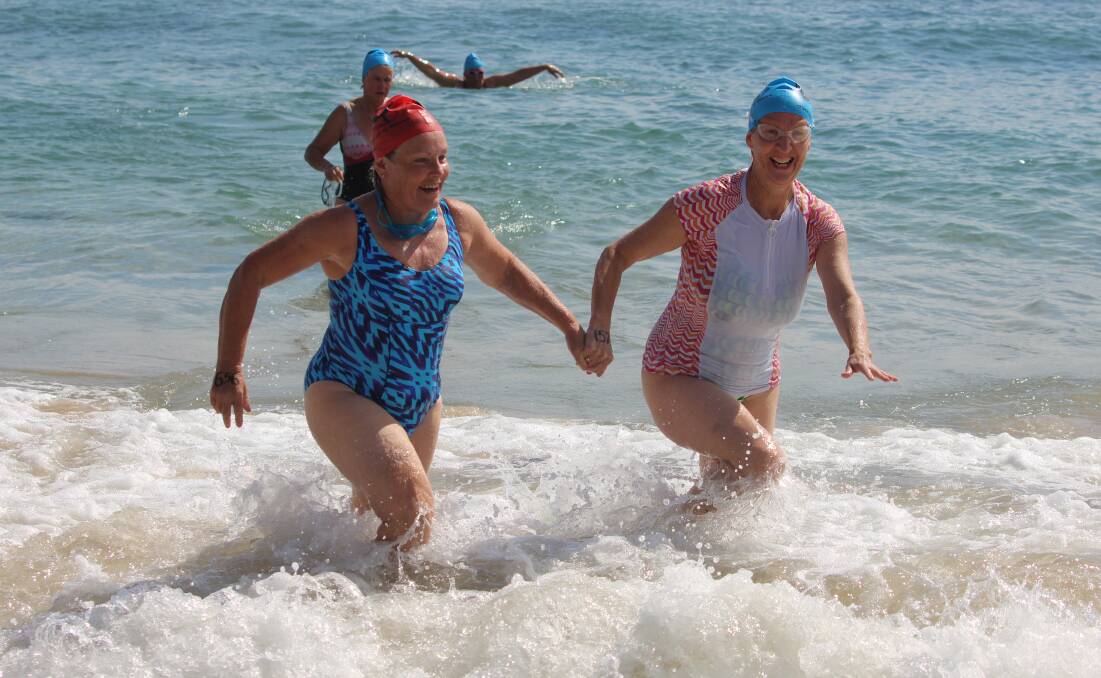 Unity: Friends emerge from the water together in the 2018 Wharf to Waves with many expecting the 2019 event to help bring people together. 