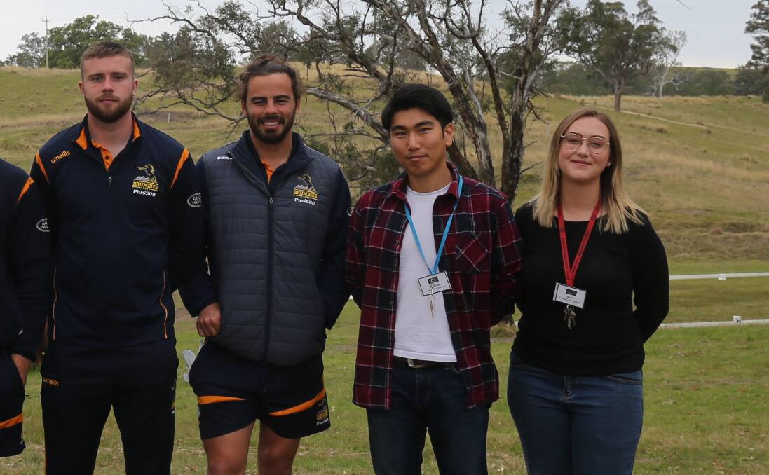 Hae Young and Katie Kim with players from the ACT Brumbies recently at the Bemboka BlazeAid camp. 