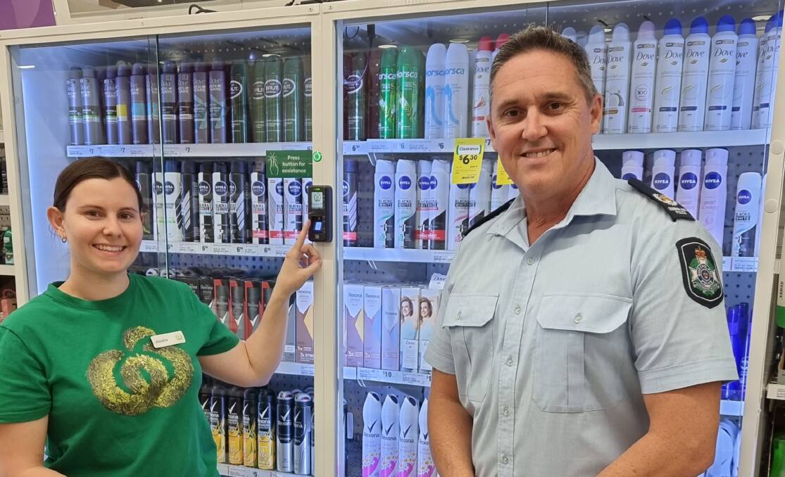 Jessica of Mount Isa Woolworths with Officer in Charge of Mount Isa Station, Acting Senior Sergeant Lyall McKelvie.
