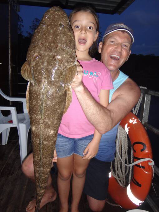 Young author Hailey Paxevanos and her dad Rob with a massive flathead she caught and released from a Clyde River houseboat over the Christmas break. 