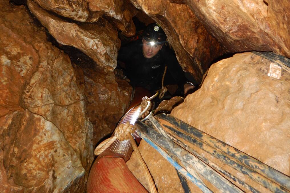 Senior Constable Markcrow inside the tight confines of the cave, during the rescue. Picture: AFP